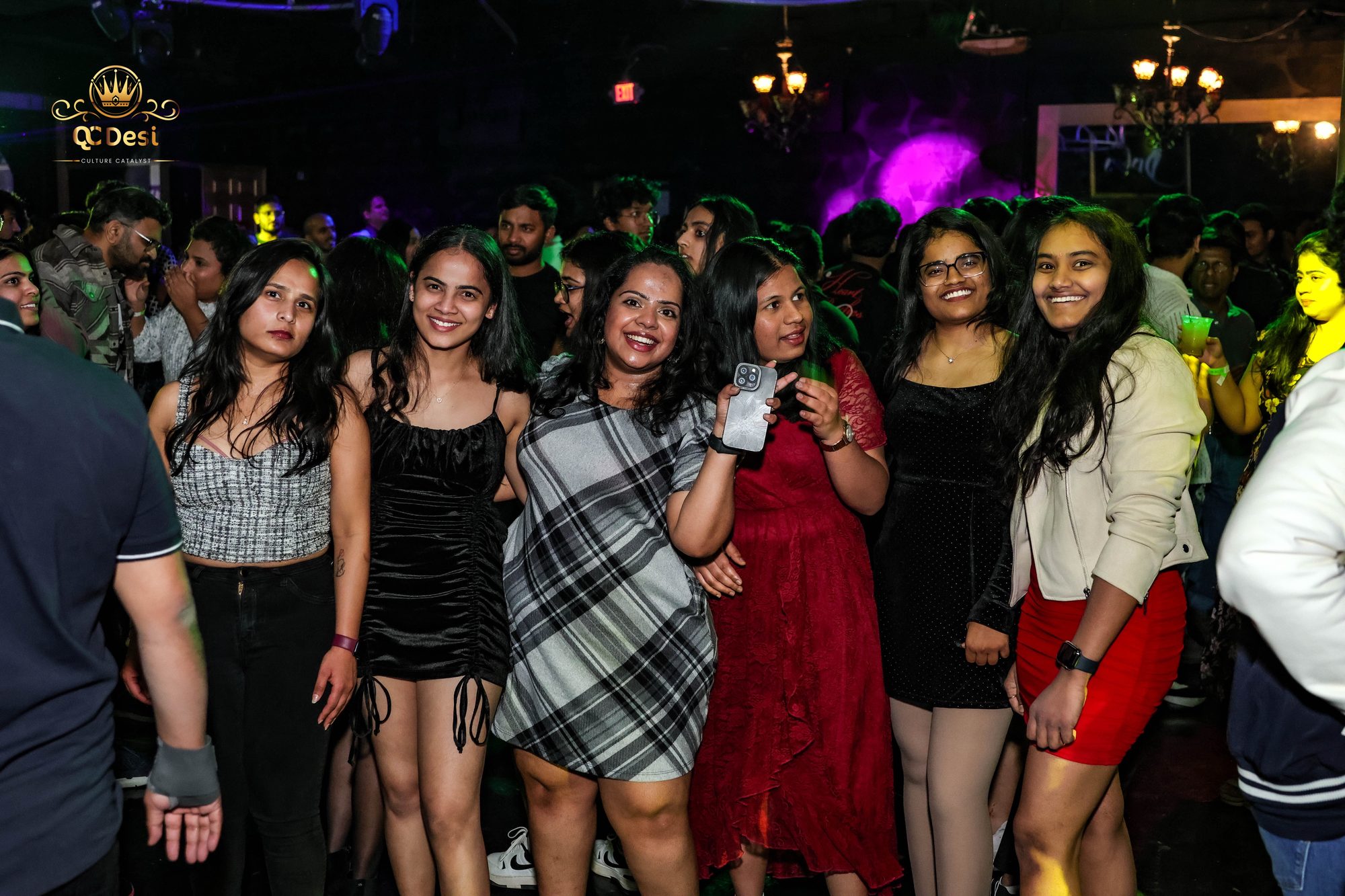 Friends smiling together in the crowd